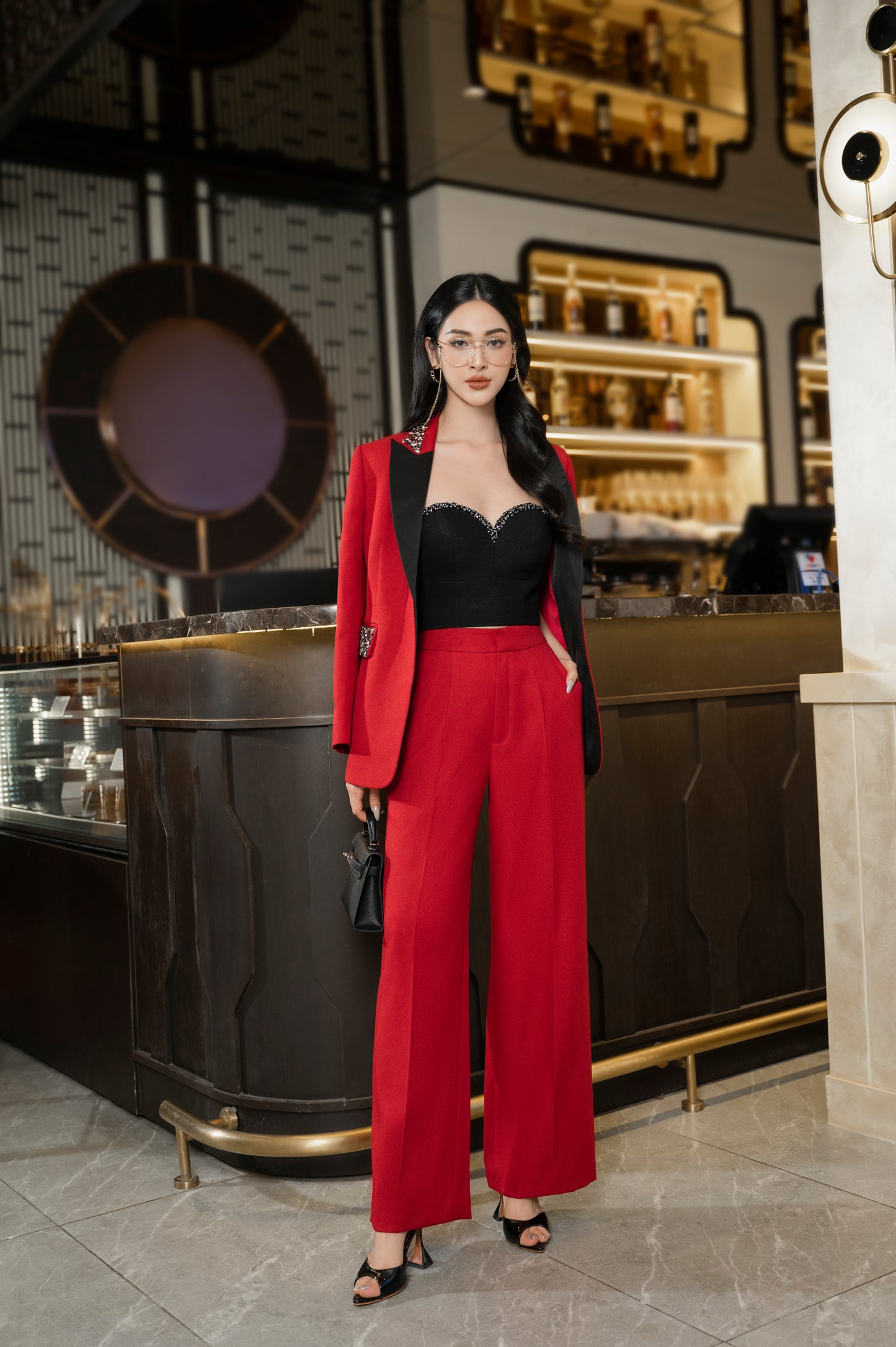 Chic Red Wide-Leg Pantsuit with Embellished Blazer and Black Bustier Top
