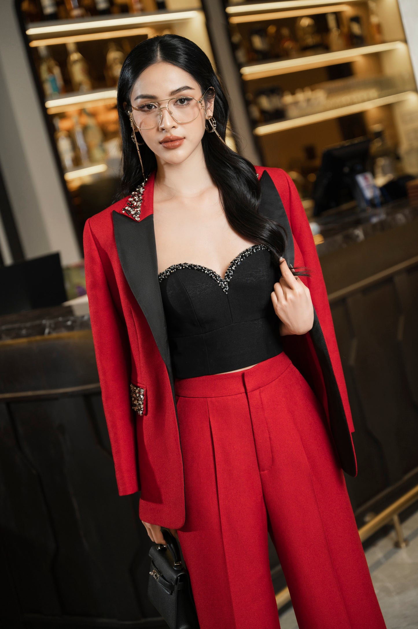 Chic Red Wide-Leg Pantsuit with Embellished Blazer and Black Bustier Top