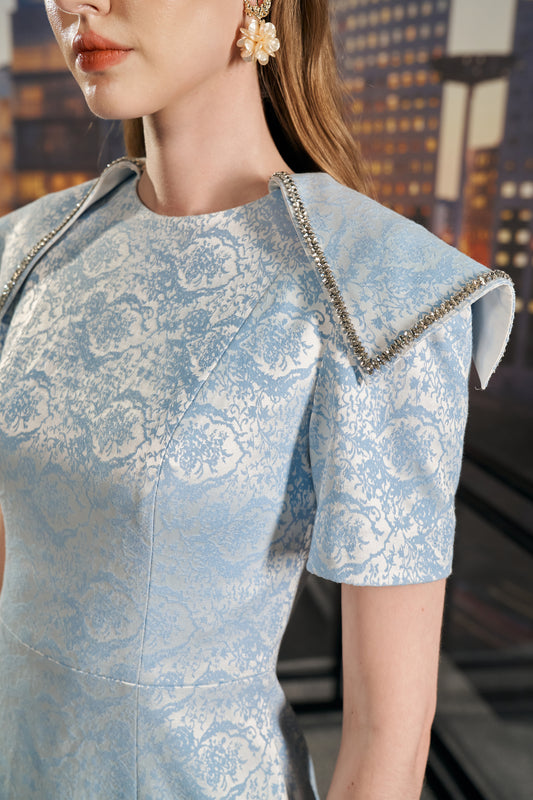 Light Blue Brocade Sheath Dress with Structured Sleeves and Geometric Accents