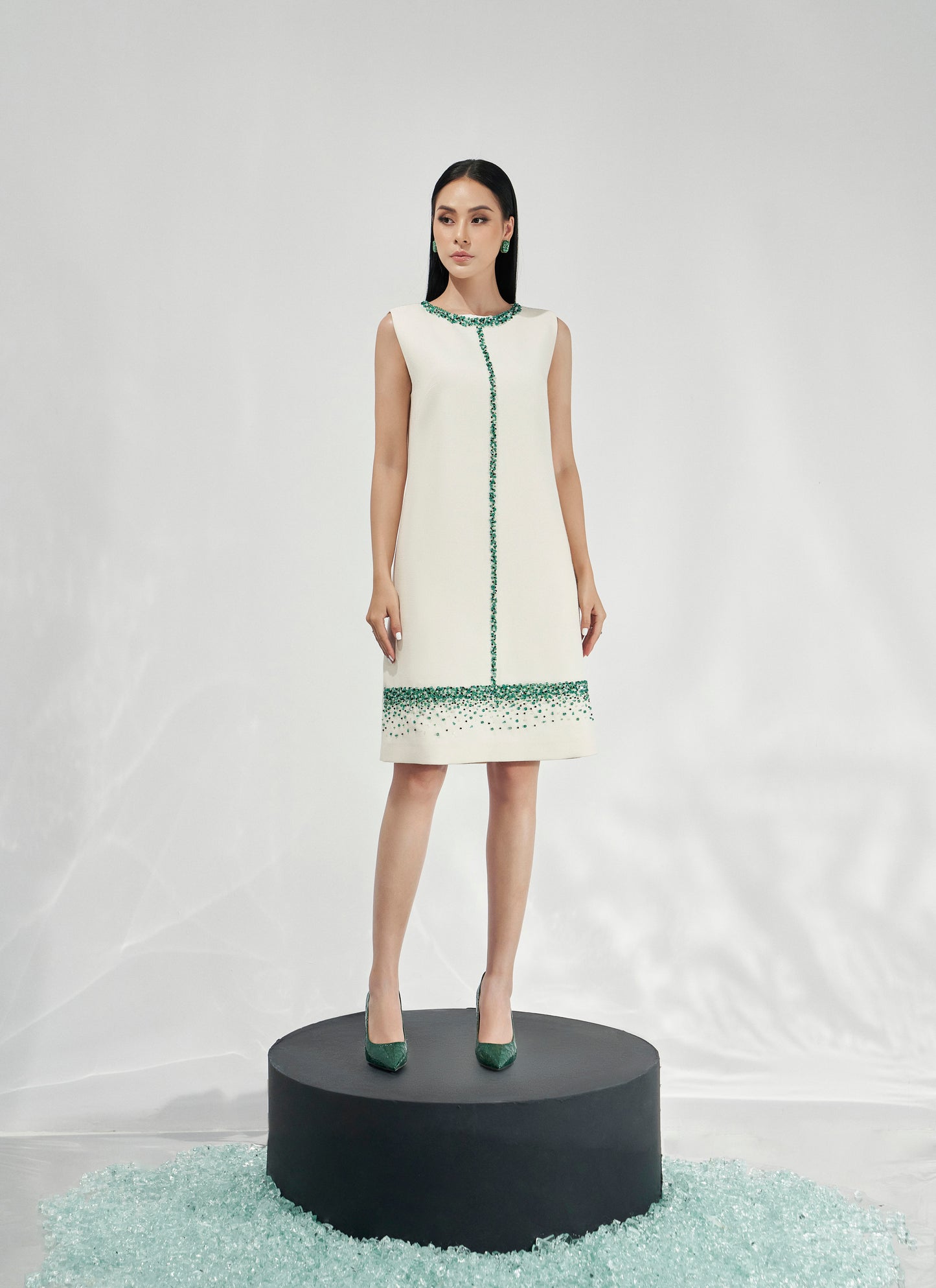 Sleeveless White Shift Dress with Green Gemstone Embellishments