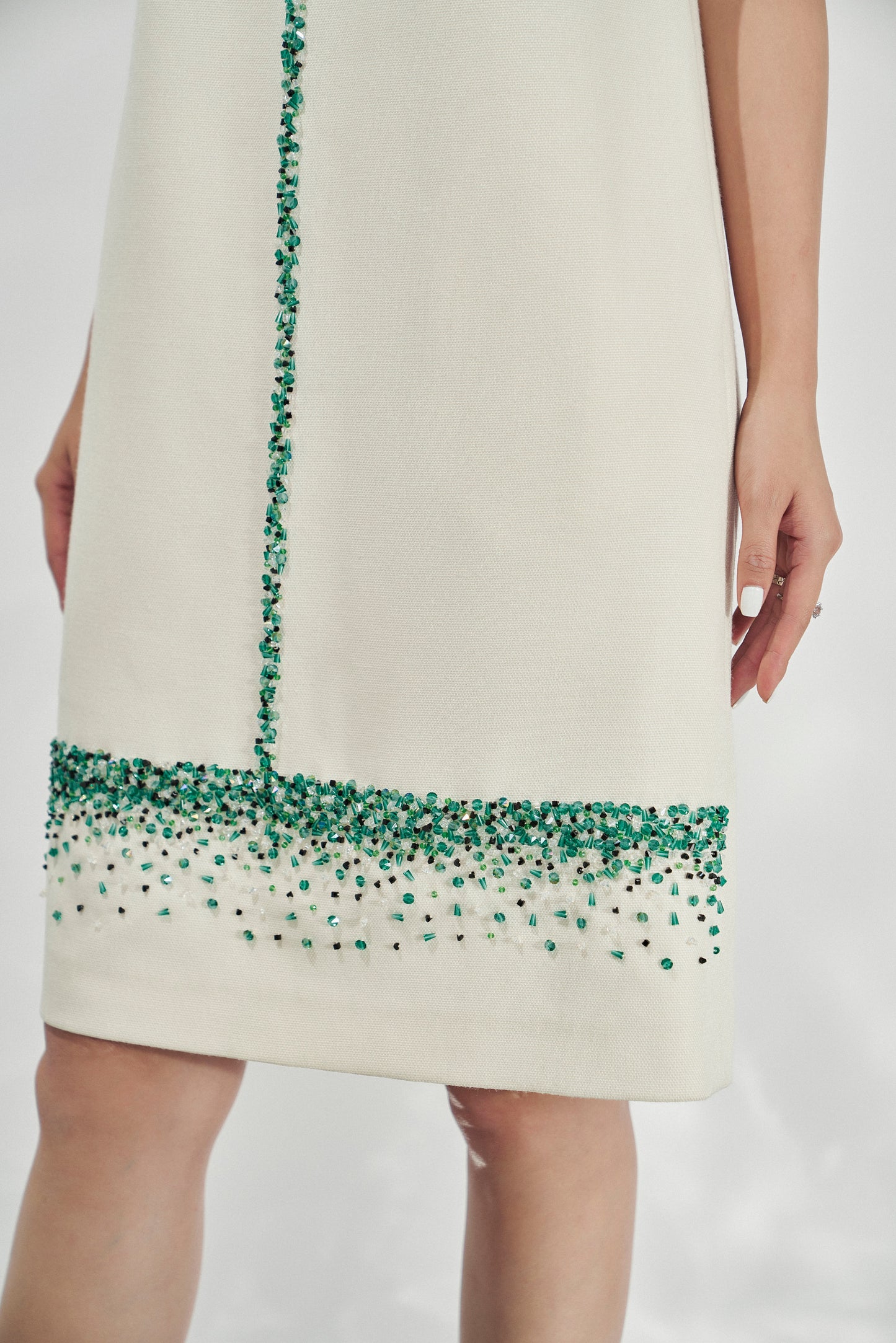 Sleeveless White Shift Dress with Green Gemstone Embellishments