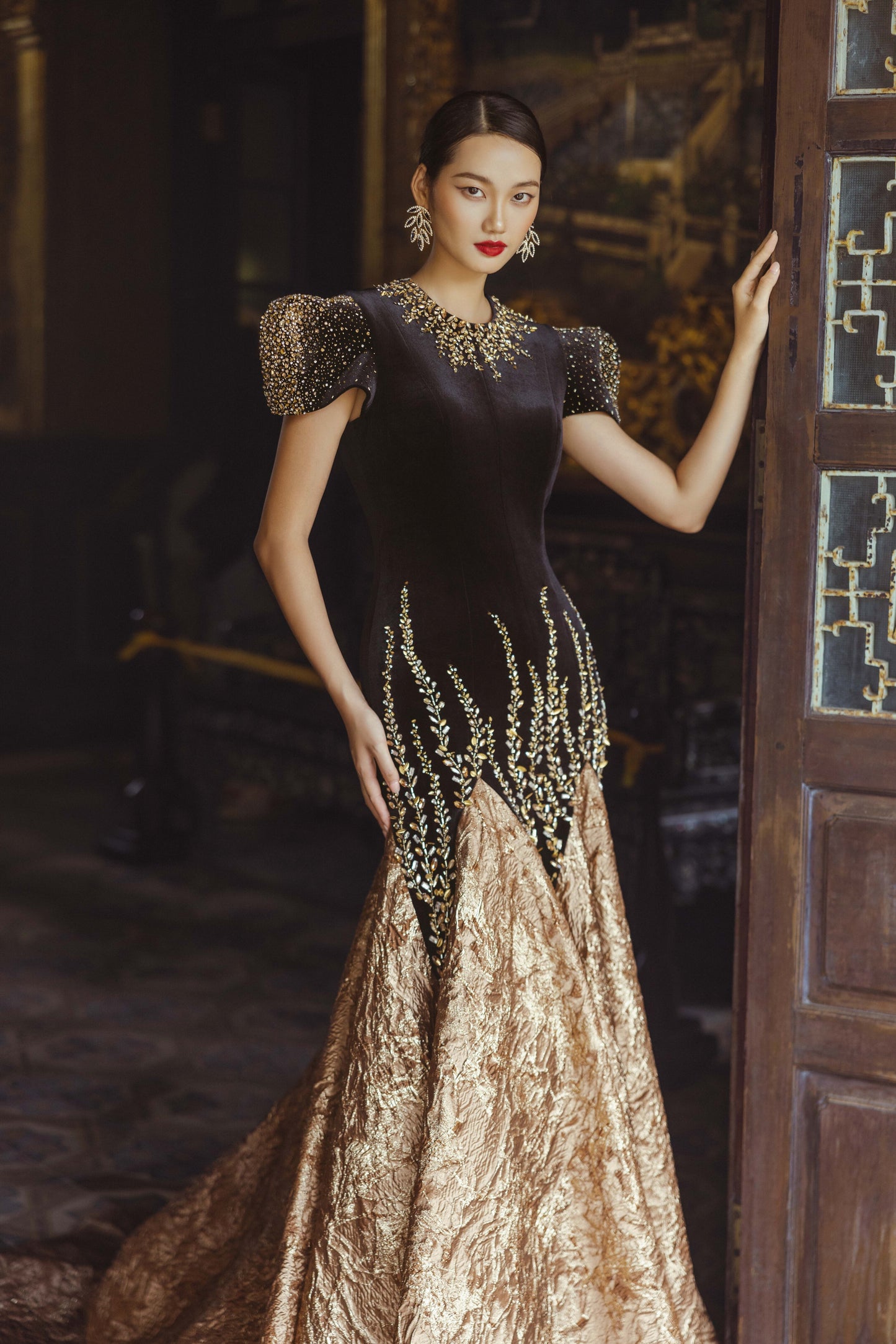 Black and Gold Velvet Gown with Embellished Sleeves and Dramatic Train