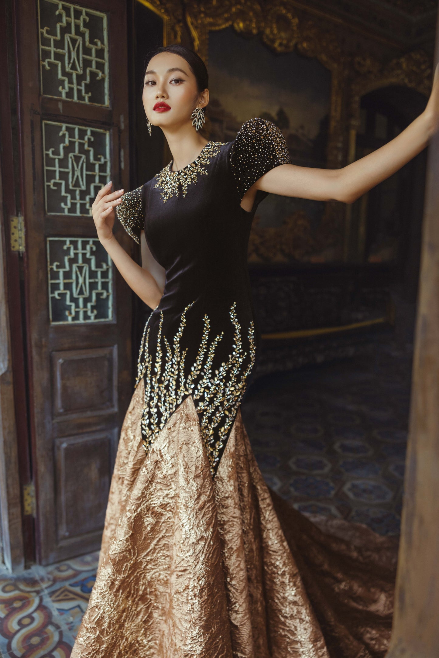 Black and Gold Velvet Gown with Embellished Sleeves and Dramatic Train