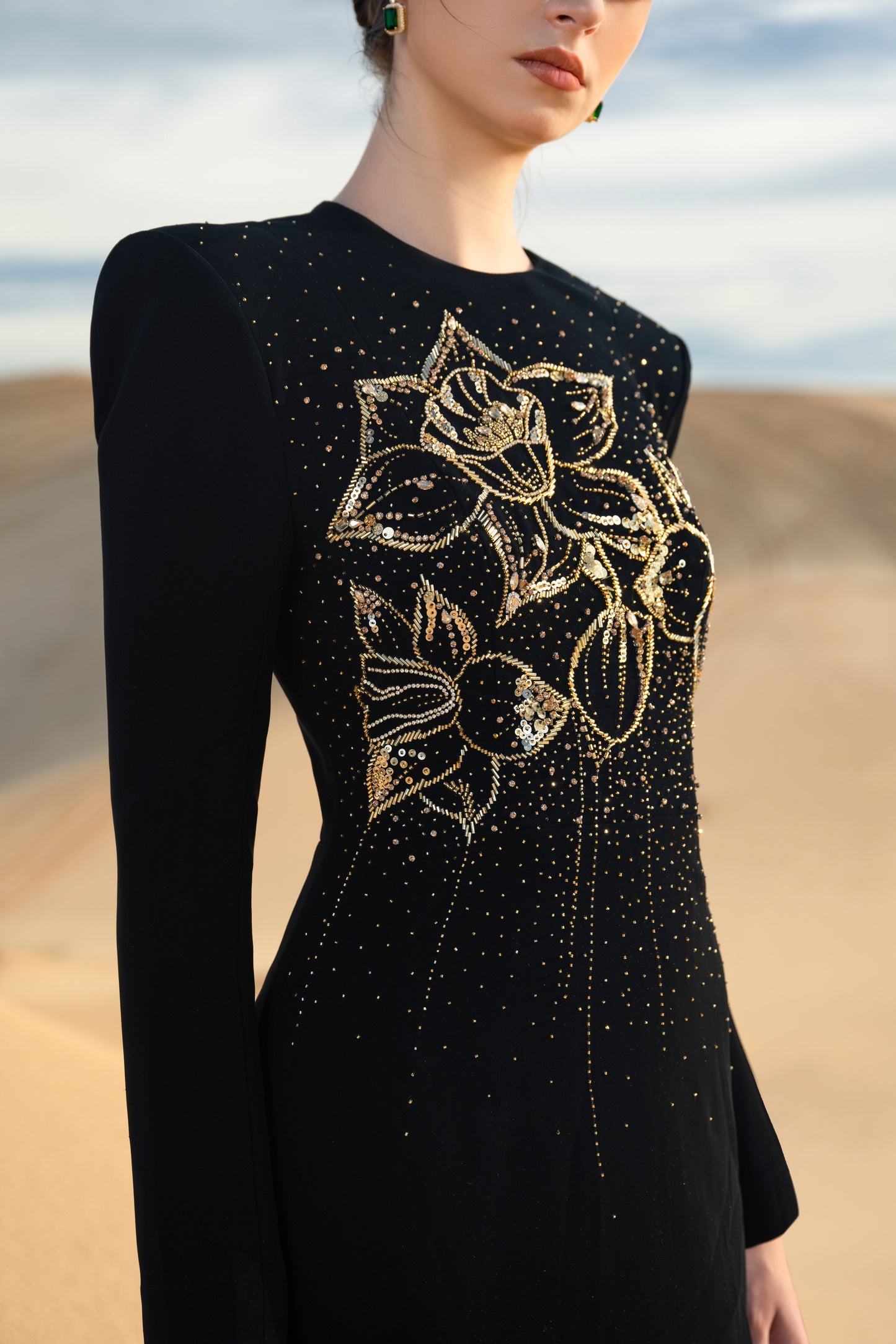 Black Floral Embellished Gown with Gold Detailing and Long Sleeves