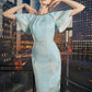 Light Blue Sheath Dress with Metallic Finish and Cape Sleeves