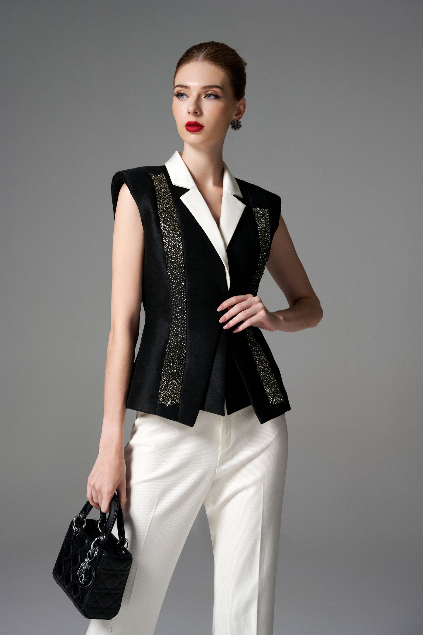 Black and White Sleeveless Blazer with Embellished Accents and Wide-Leg Trousers