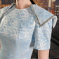 Light Blue Brocade Sheath Dress with Structured Sleeves and Geometric Accents