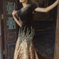 Black and Gold Velvet Gown with Embellished Sleeves and Dramatic Train